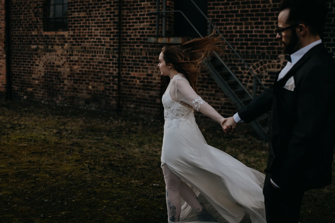 Couple with windy hair outside the Newbattle Mining Museum - Scotland elopement photographer