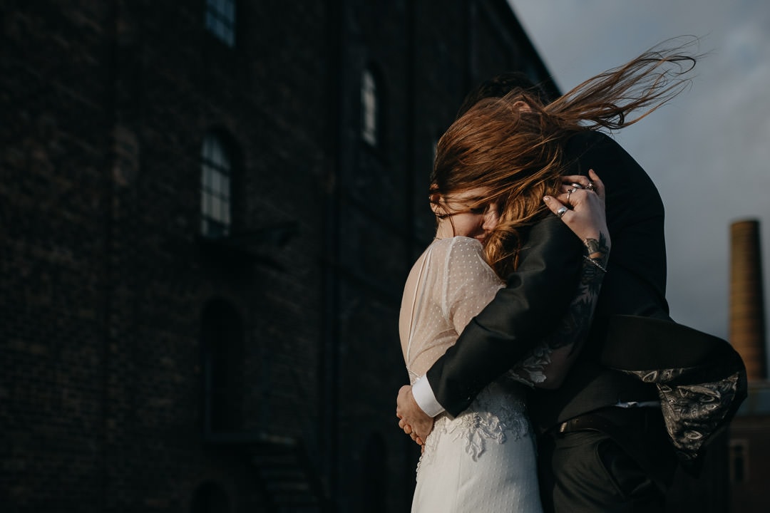 Couple with windy hair outside the Newbattle Mining Museum - Scotland elopement photographer