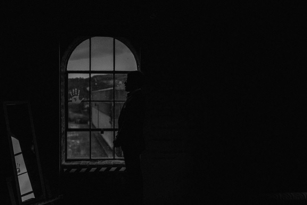 Moody elopement photos of groom in Scotland