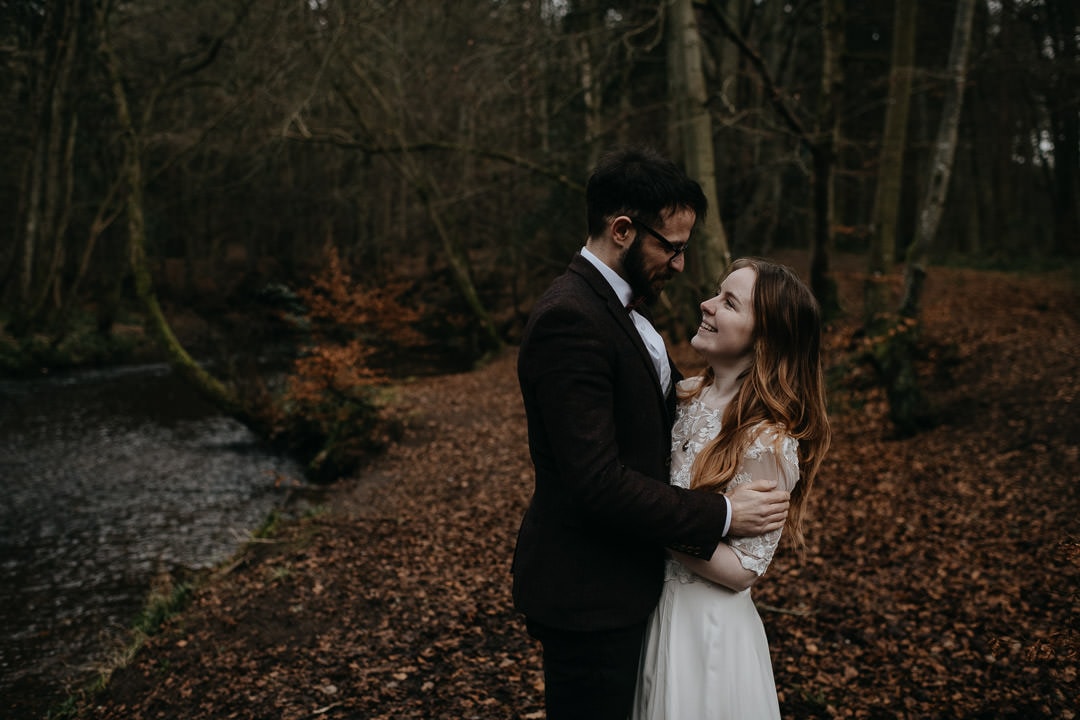Elopement couple in Scottish woodland looking happy