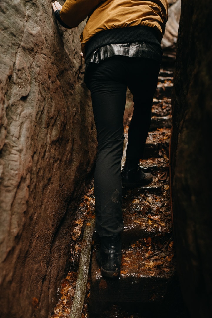 adventurous couple rock climbing in Devil's Pulpit elopement in Scotland