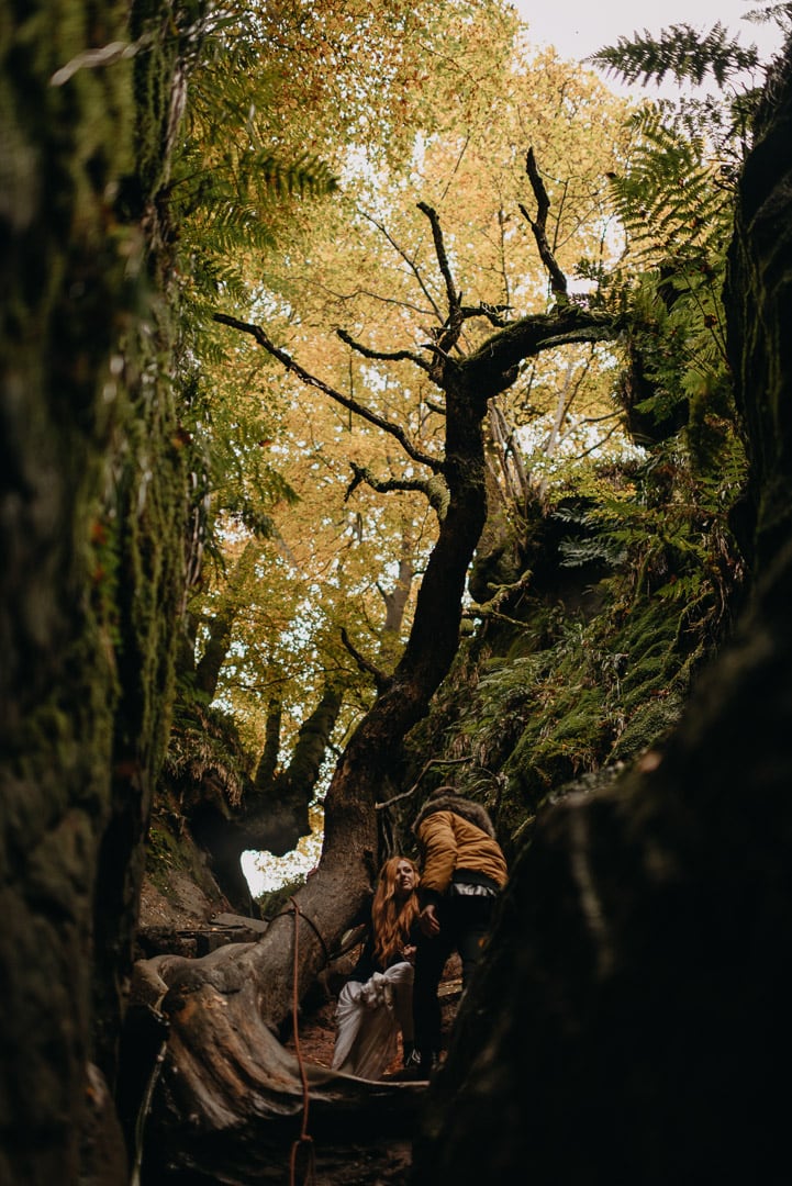 adventurous couple rock climbing in Devil's Pulpit elopement in Scotland