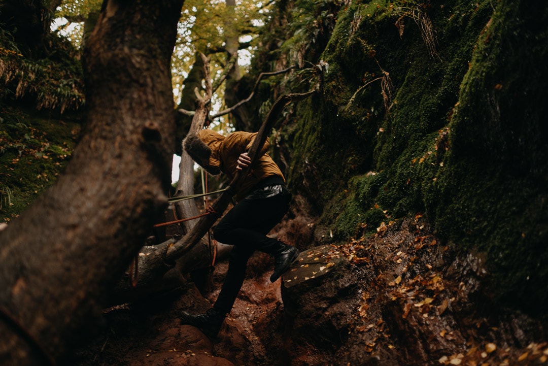 adventurous couple rock climbing in Devil's Pulpit elopement in Scotland