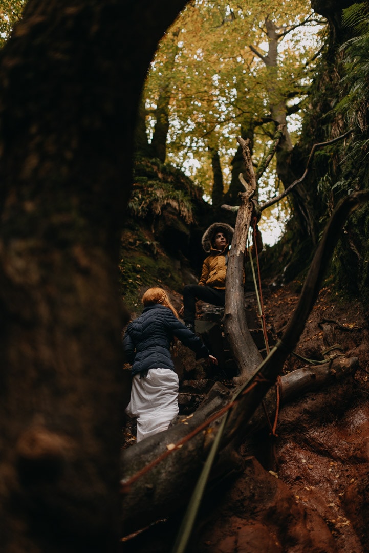 adventurous couple rock climbing in Devil's Pulpit elopement in Scotland