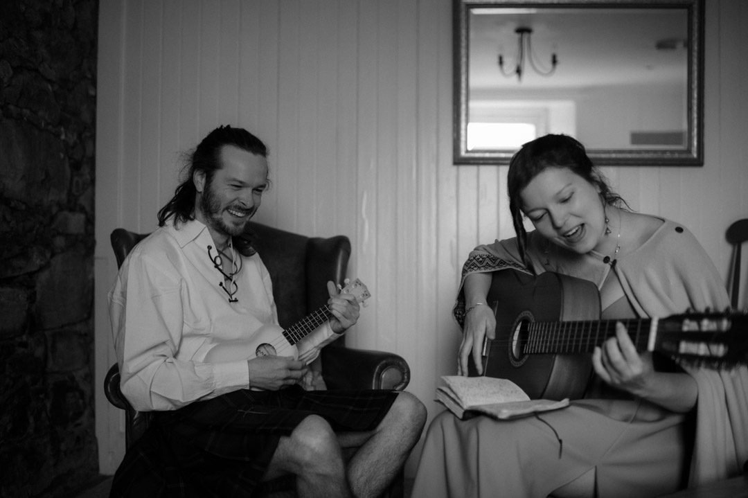 Isle of Mull elopement couple playing guitar together