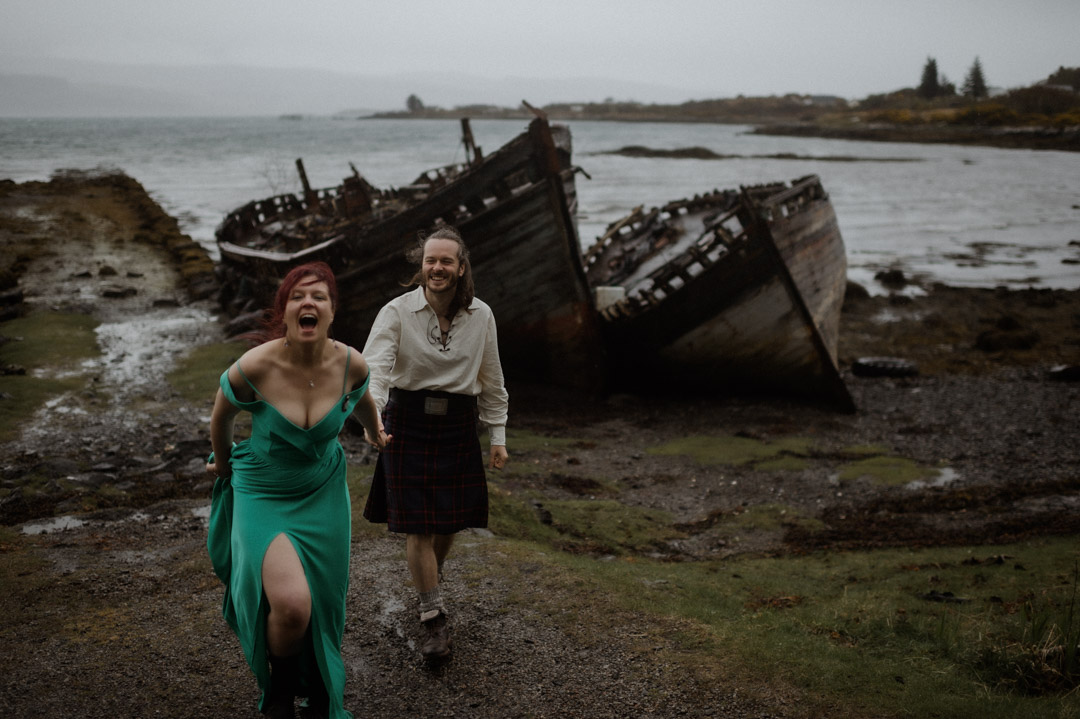 Isle of Mull joyful elopement couple at shipwrecked boats