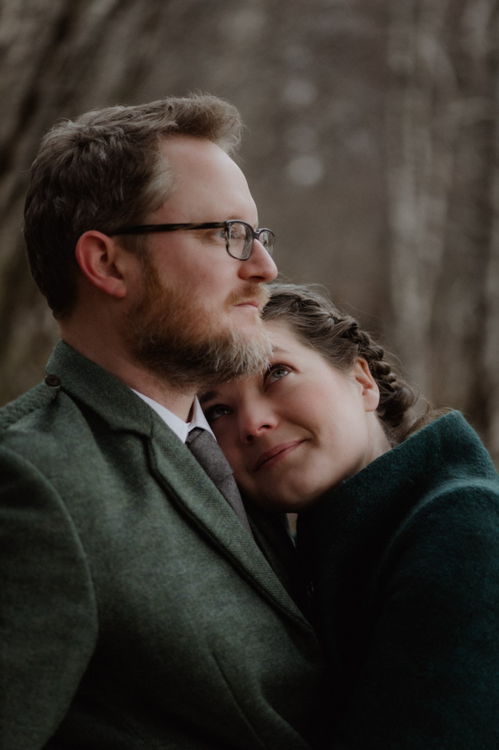 Outlander elopement couple by trees and loch in Scottish Highlands