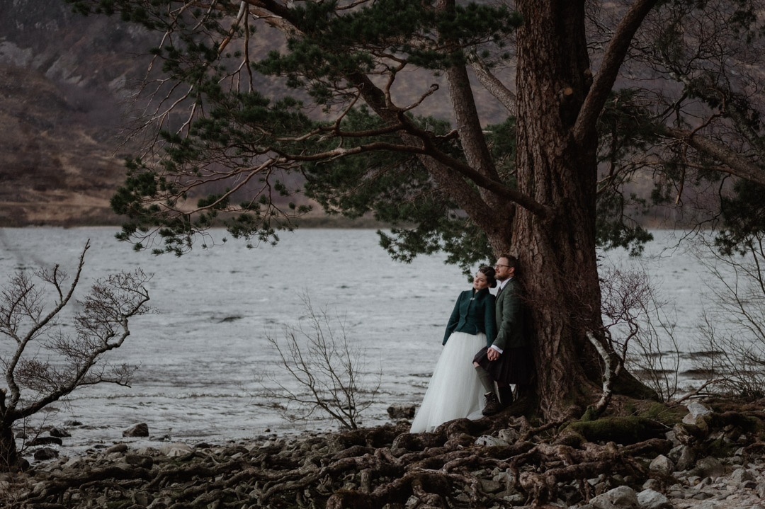 Winter elopement couple in Torridon by trees and mountains