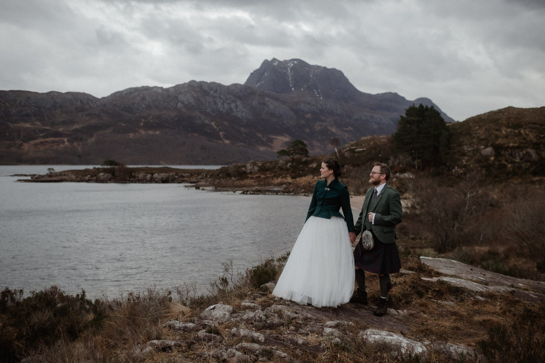 Winter elopement couple in Torridon by trees and mountains
