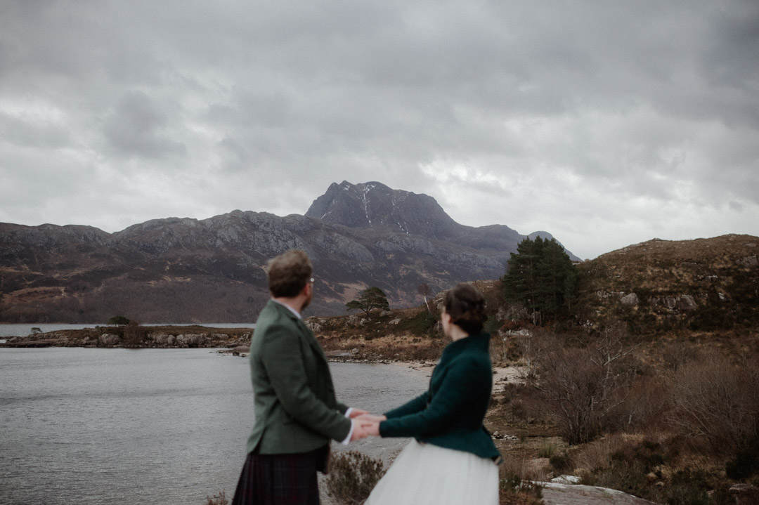 Winter elopement couple in Torridon by trees and mountains