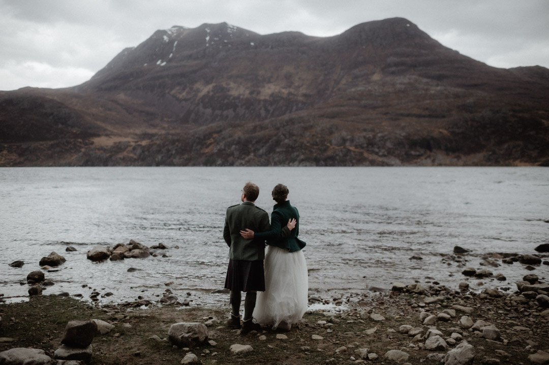 Couple by loch at elopement in the Scottish Highlands, Torridon