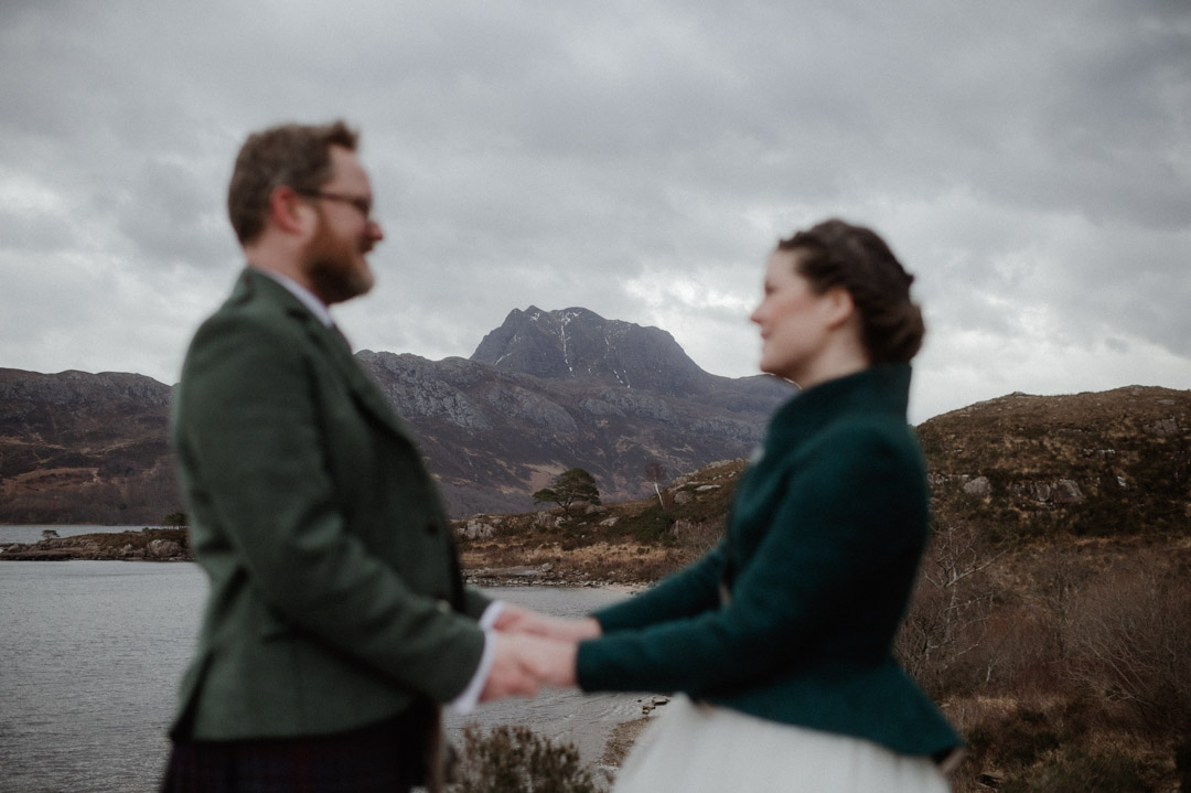 Winter elopement couple in Torridon by trees and mountains