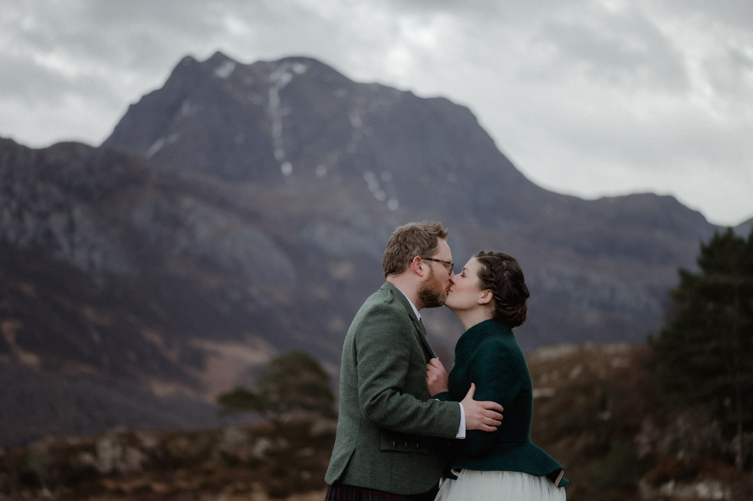 Winter elopement couple in Torridon by trees and mountains