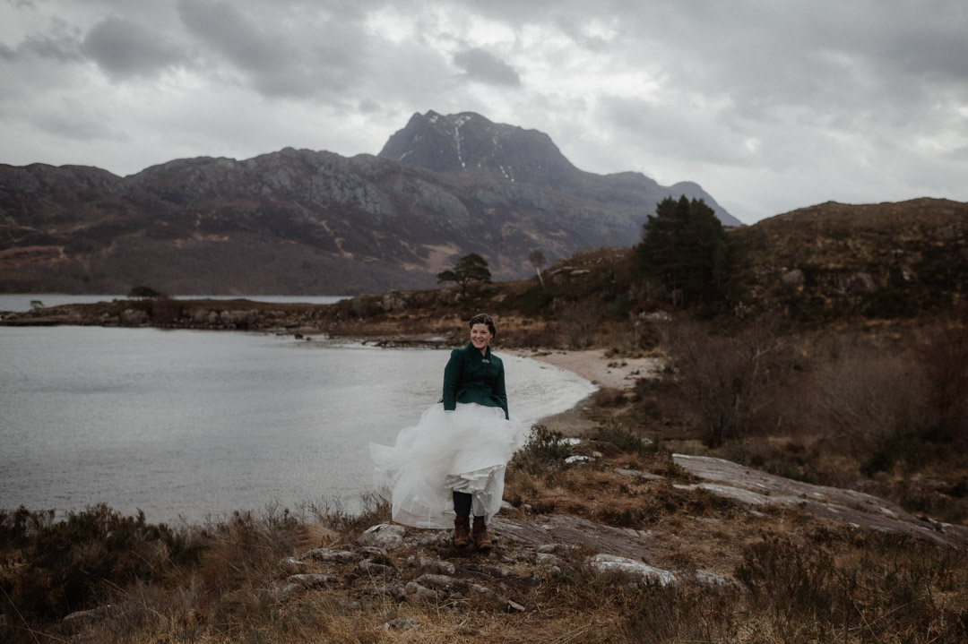 Winter elopement couple in Torridon by trees and mountains