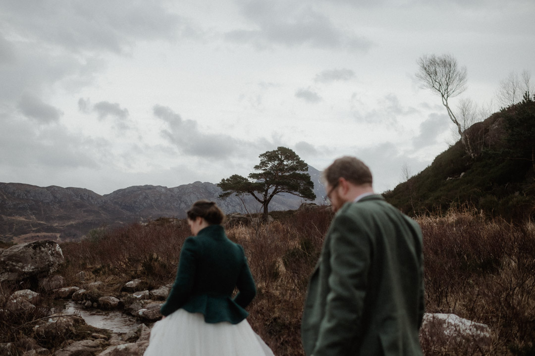 Winter elopement couple in Torridon by trees and mountains