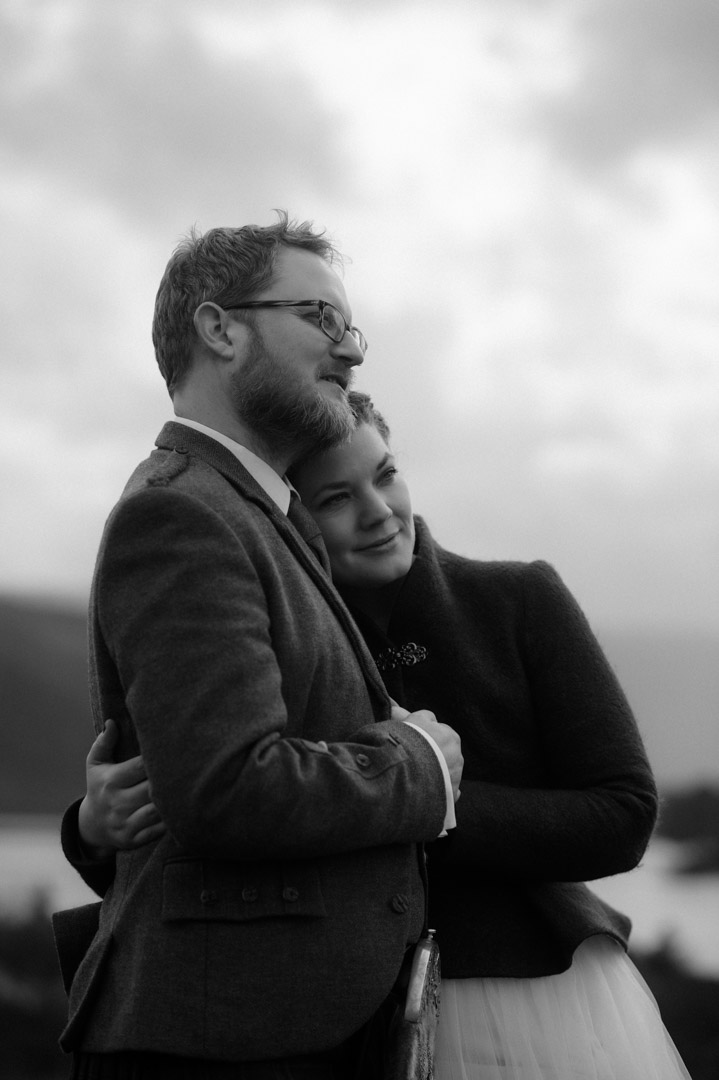 Couple cuddling during winter elopement in Scotland