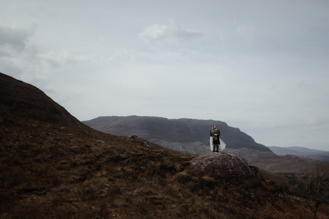 Winter elopement in Scottish hills wearing Outlander outfits and kilt