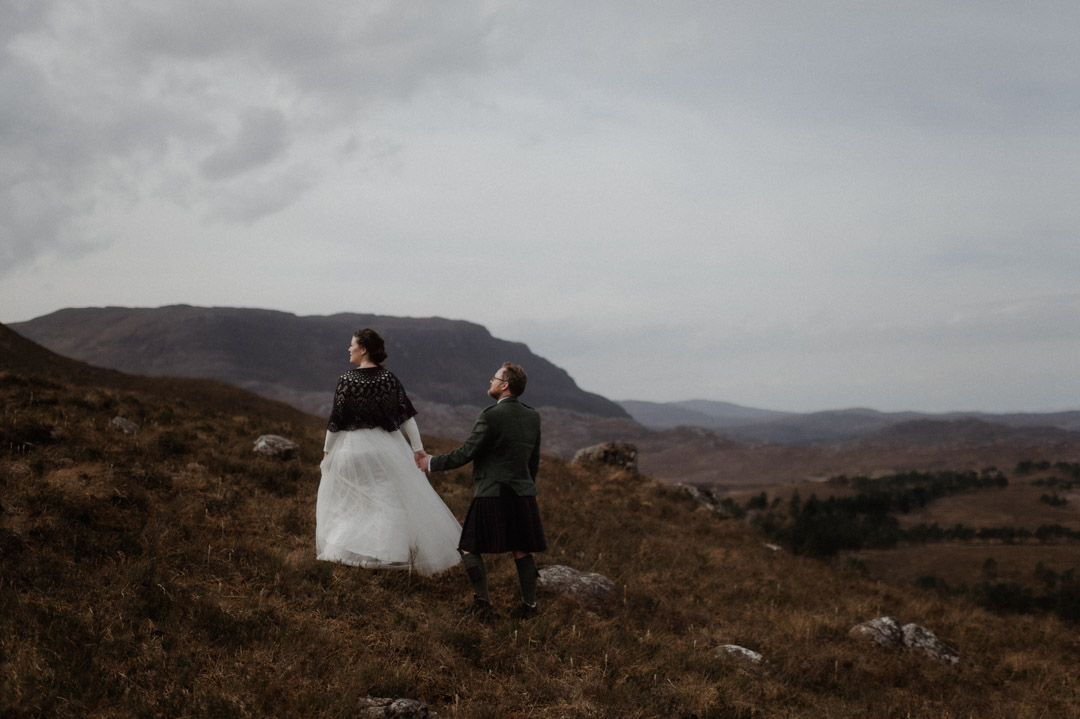 Winter elopement in Scottish hills wearing Outlander outfits and kilt