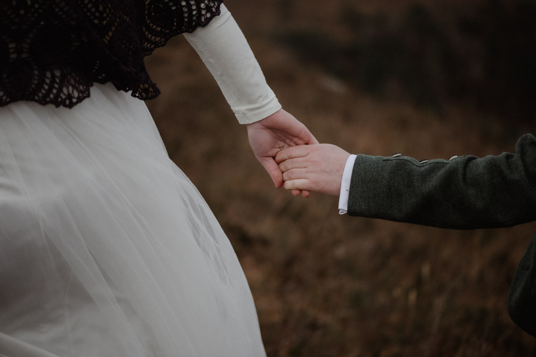 Holding hands at Scottish elopement