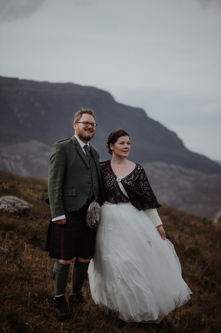 Winter elopement in Scottish hills wearing Outlander outfits and kilt