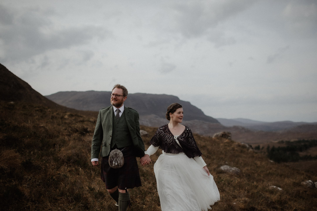 Winter elopement in Scottish hills wearing Outlander outfits and kilt