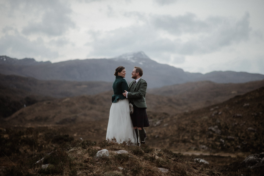 Winter elopement in Scottish hills wearing Outlander outfits and kilt