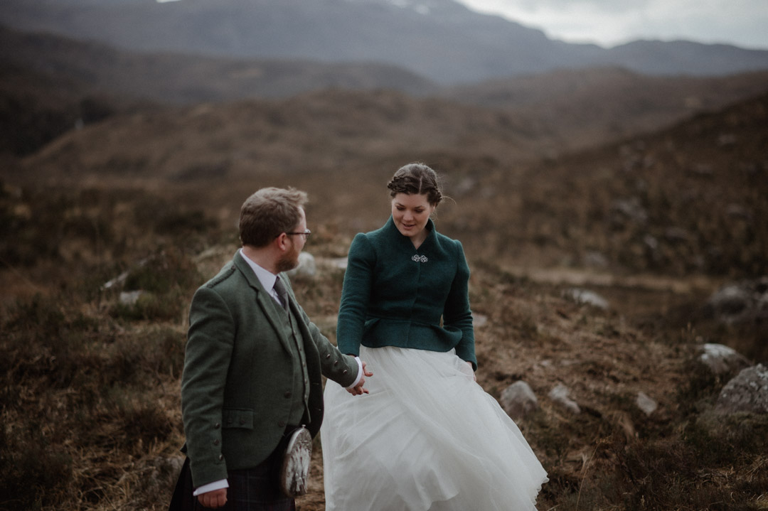 Winter elopement in Scottish hills wearing Outlander outfits and kilt