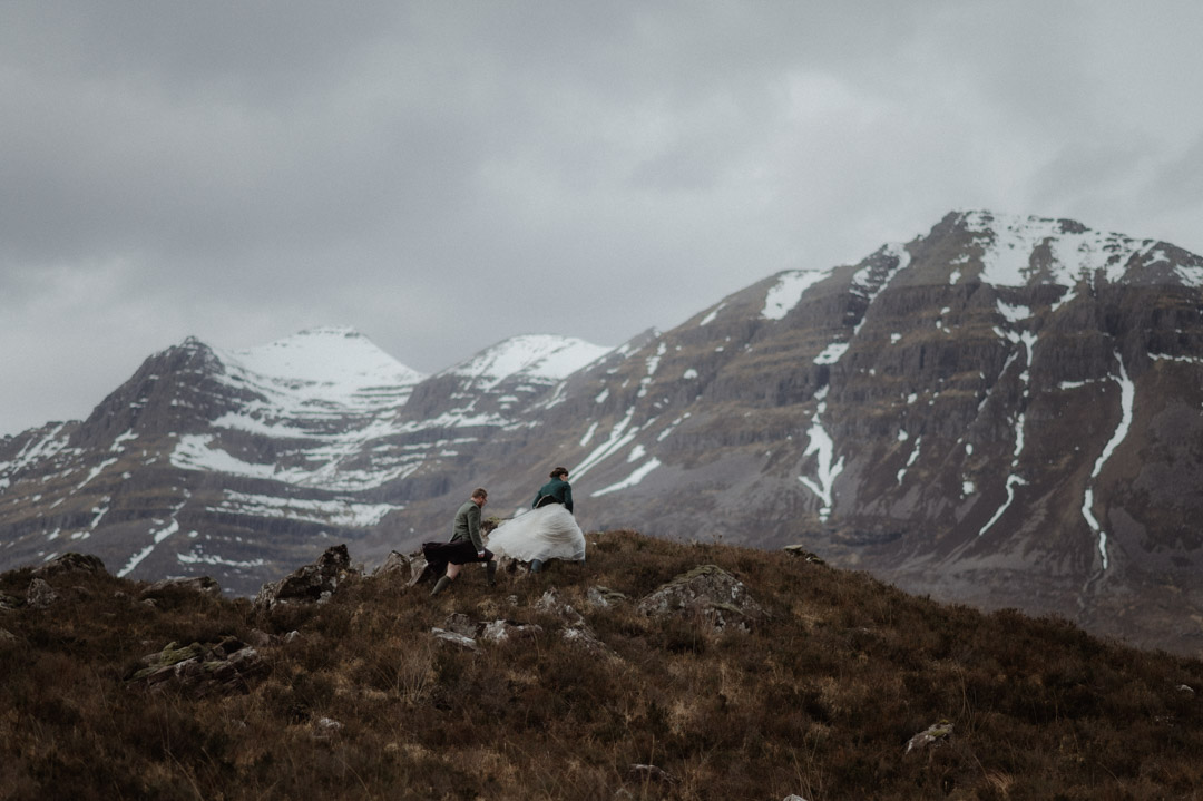 Walking in hills during winter elopement in Scotland