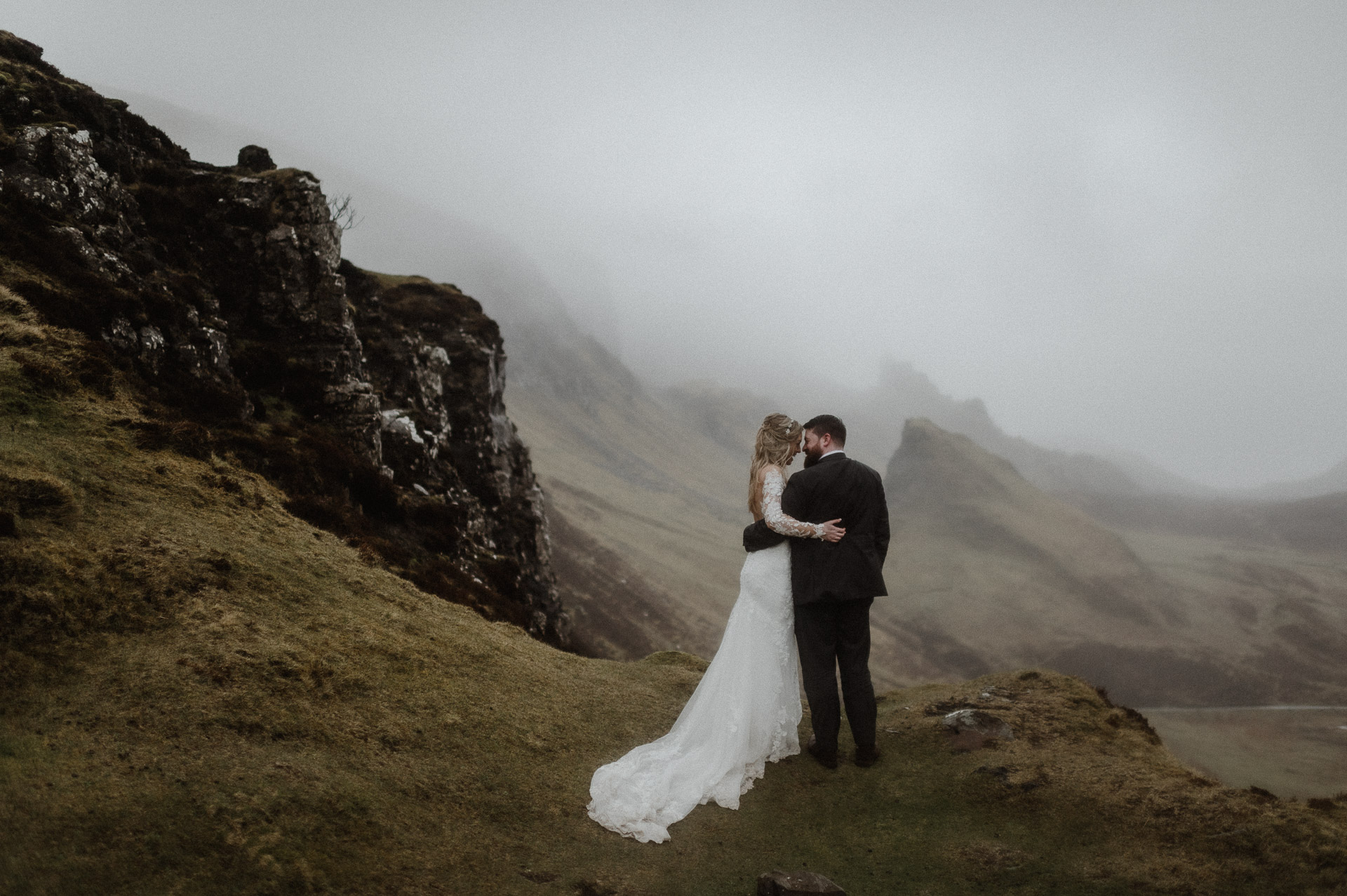 Spring misty Isle of Skye elopement bride and groom cuddling