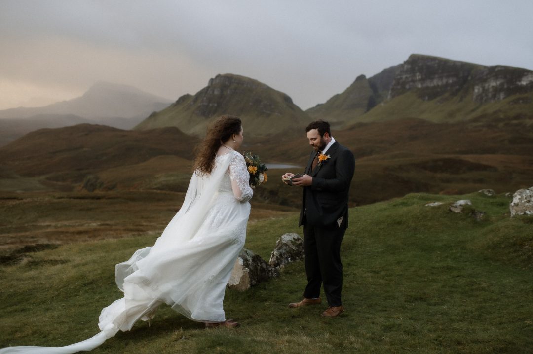 Couple saying their vows at the Quiraing on Skye during cinematic ethereal sunrise