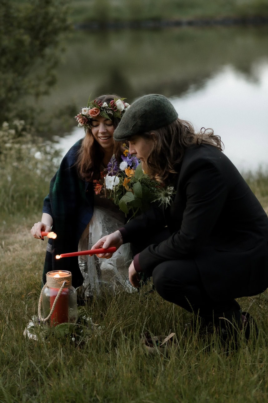 pagan solstice elopement in Edinburgh - couple light candles in elopement ceremony
