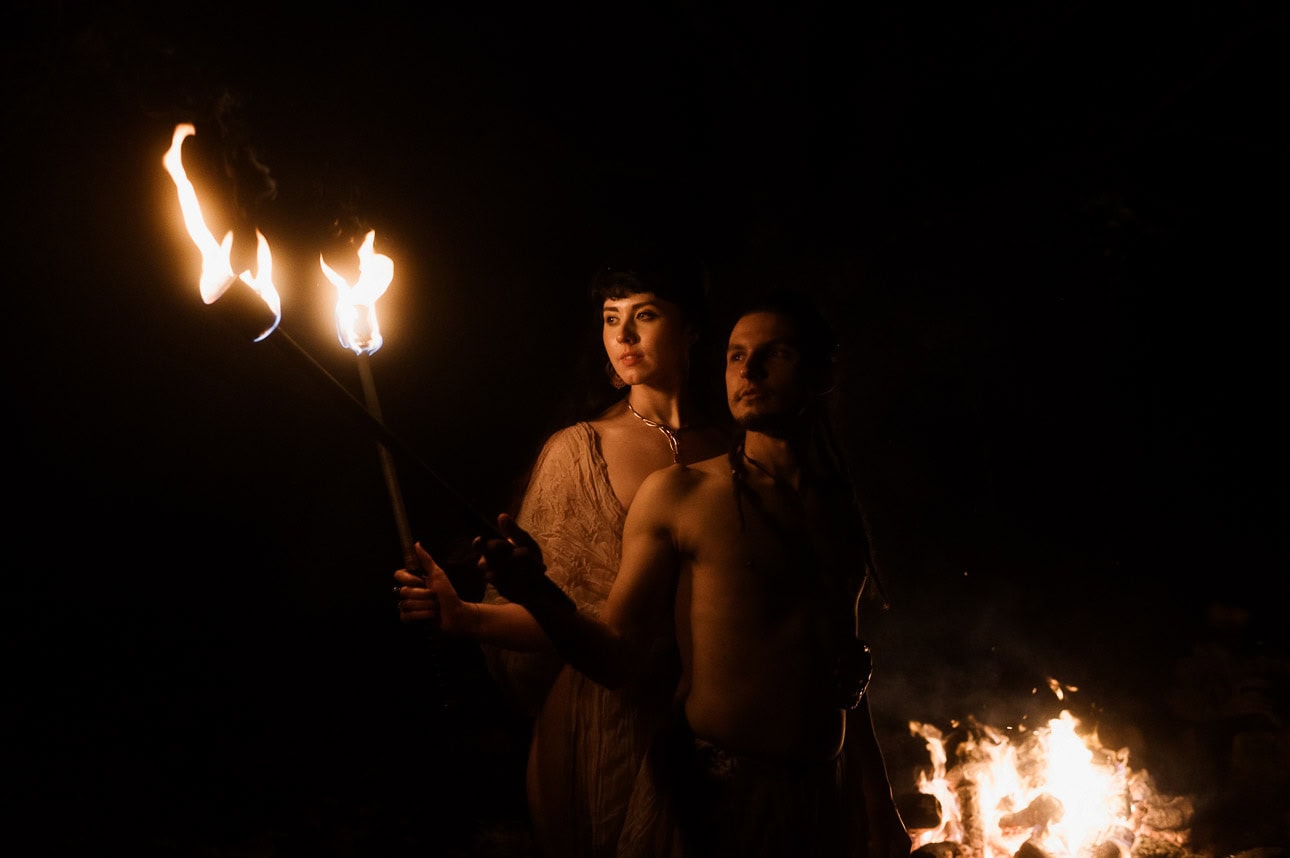 romantic elemental Beltane moment - bride and groom holding fire